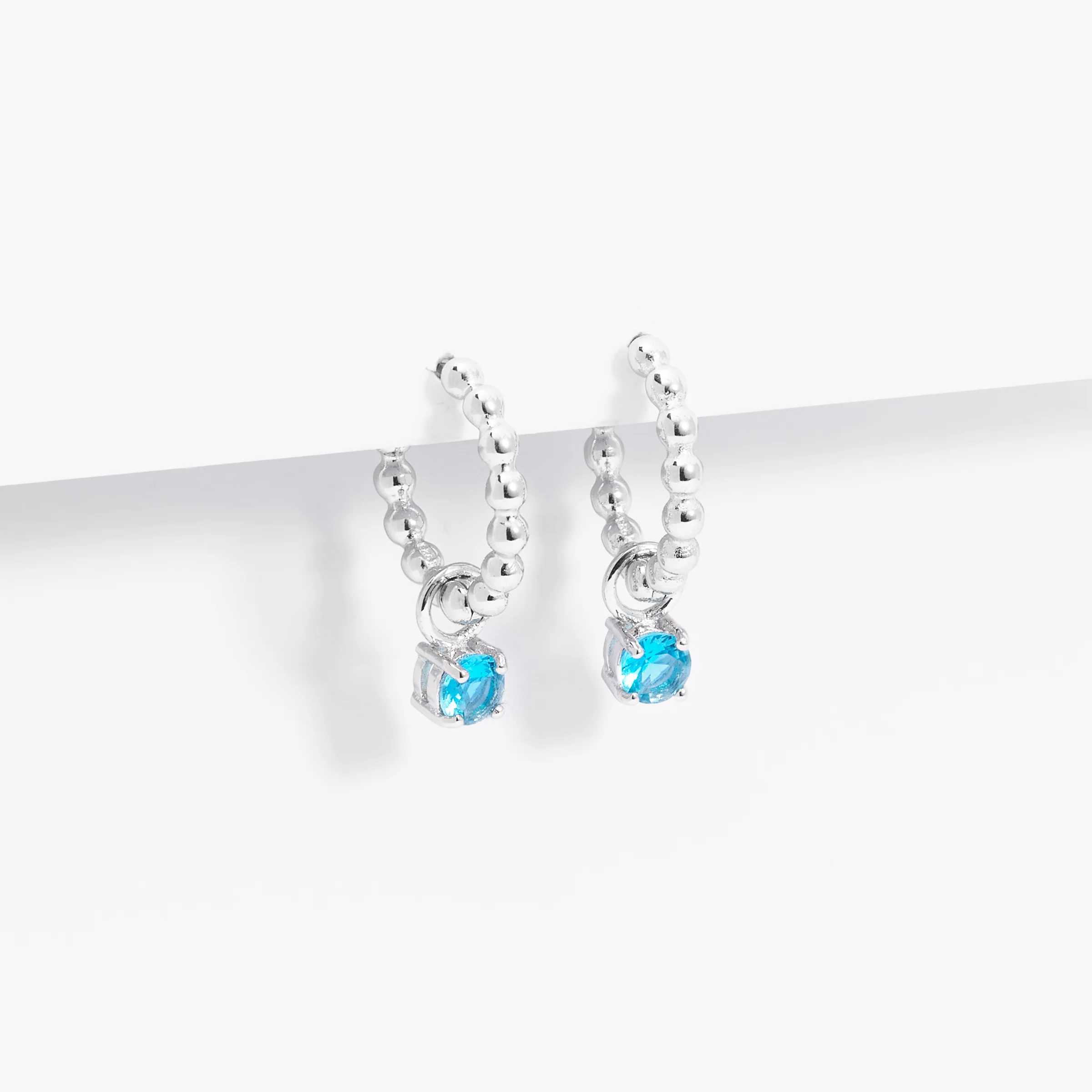 Sterling Silver Beaded Huggie Earrings With Blue Zirconia December Birthstone Drop - Image 2