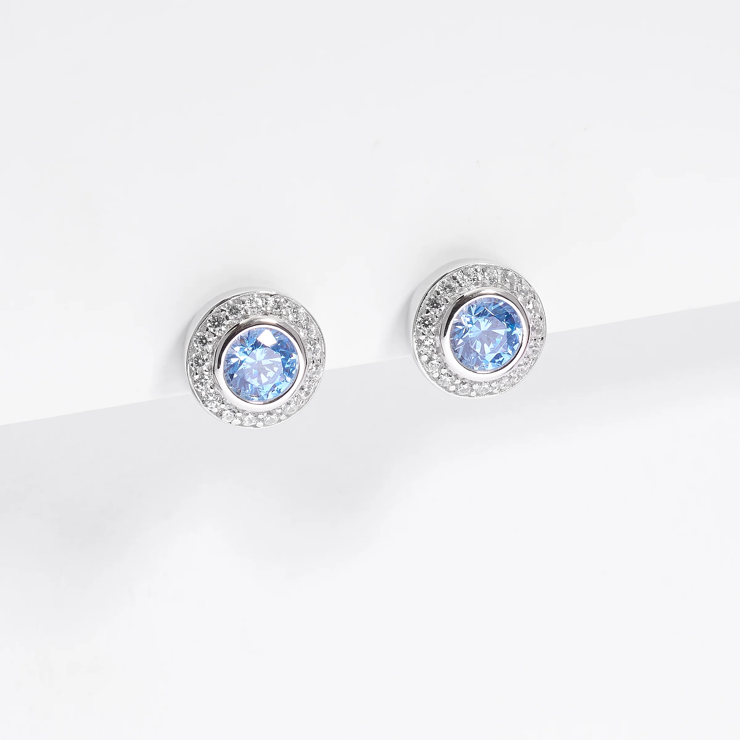Sterling Silver Bezel Blue Zirconia Halo Stud Earrings - Image 2