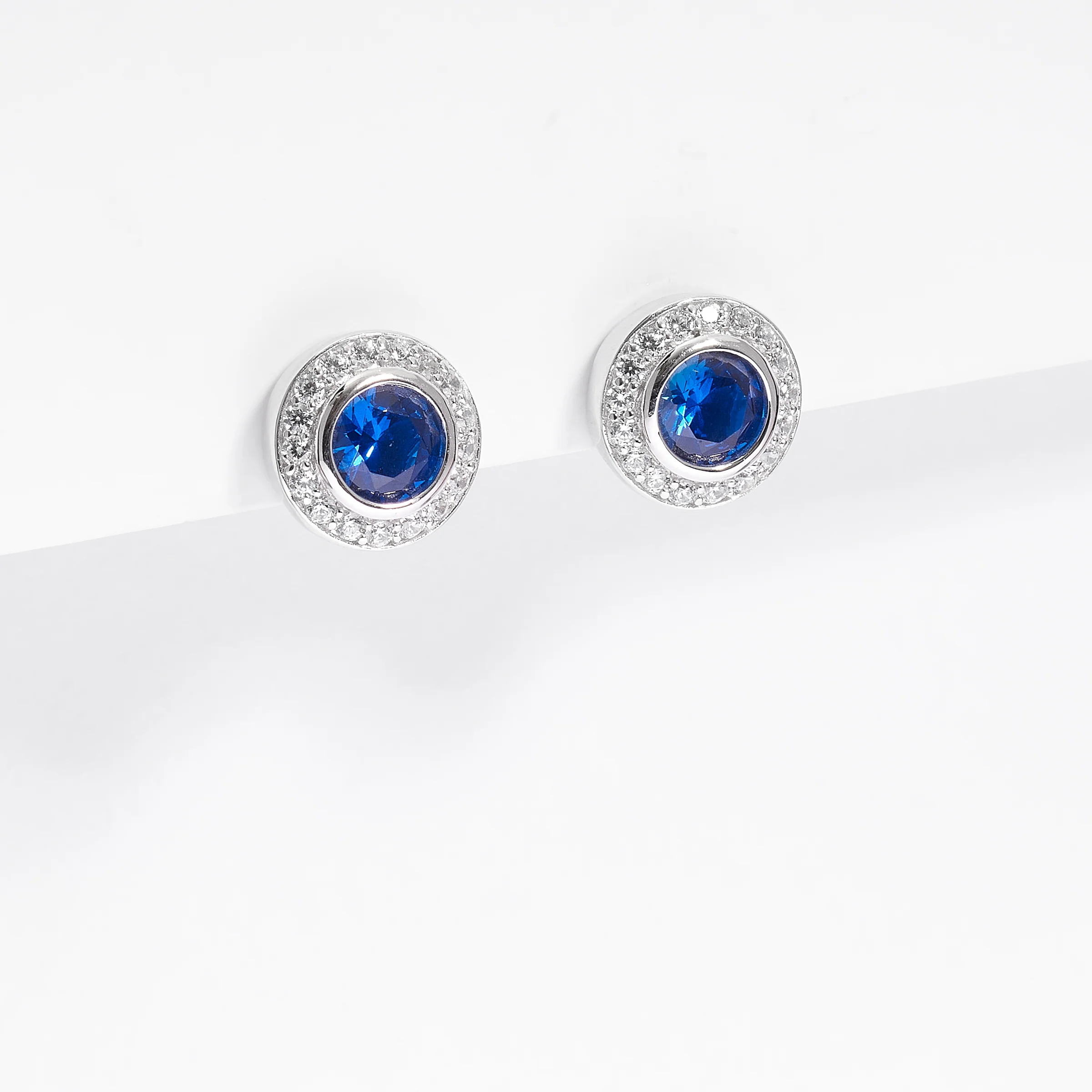 Sterling Silver Bezel Royal Blue Zirconia And Halo Stud Earrings - Image 2