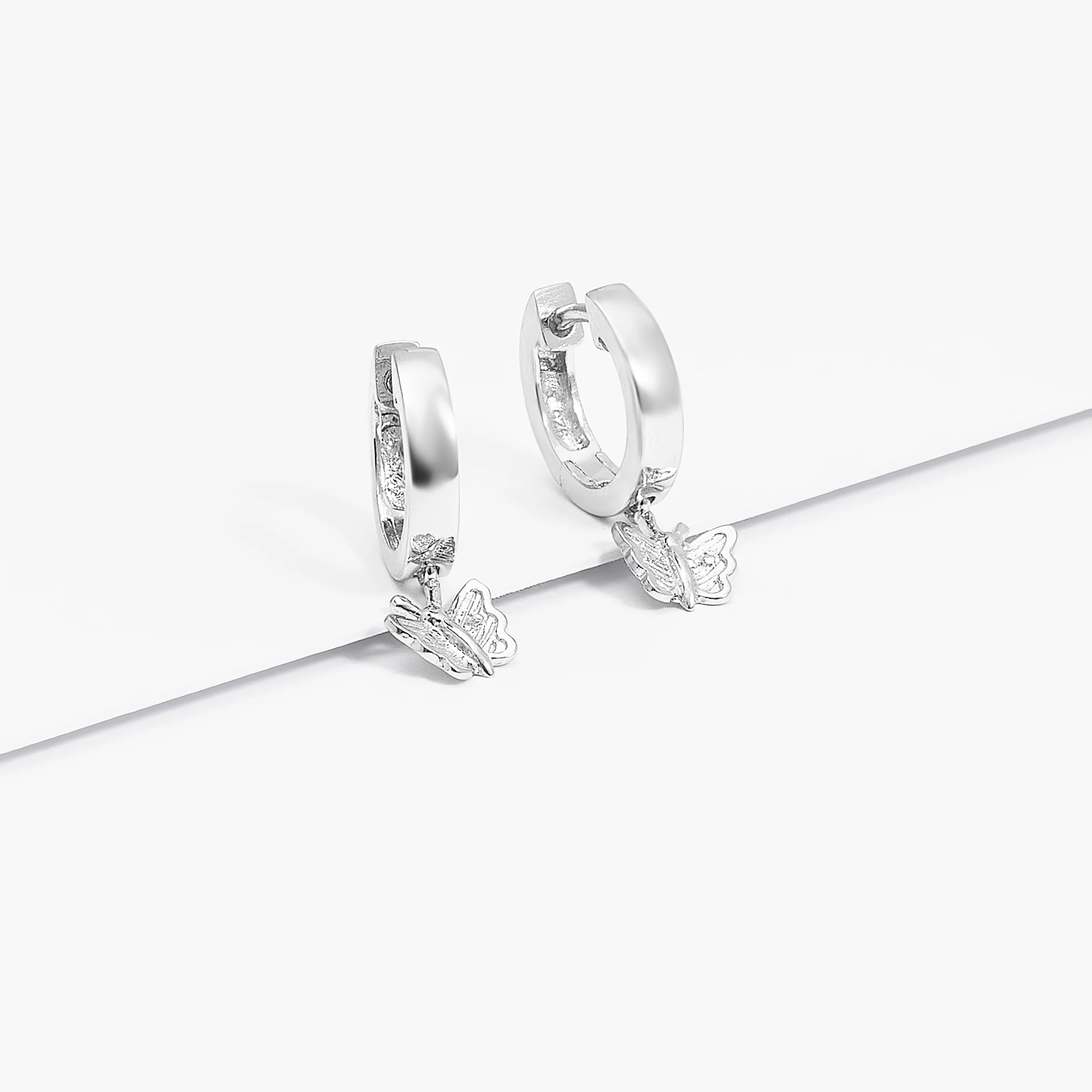 Sterling Silver Huggie Earrings With Dangling Butterfly - Image 3