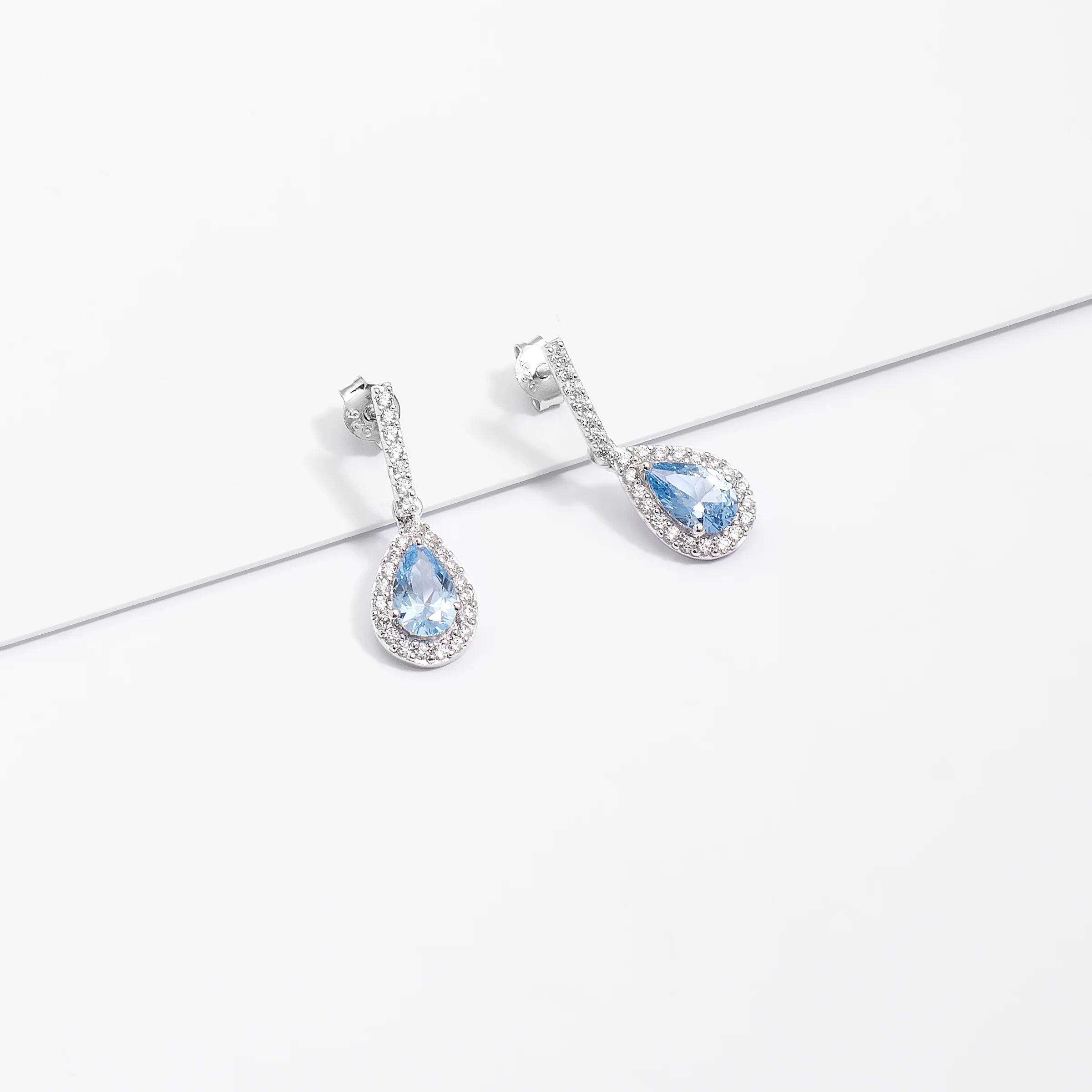 Sterling Silver Pale Blue Pear Zirconia Halo Earrings - Image 3